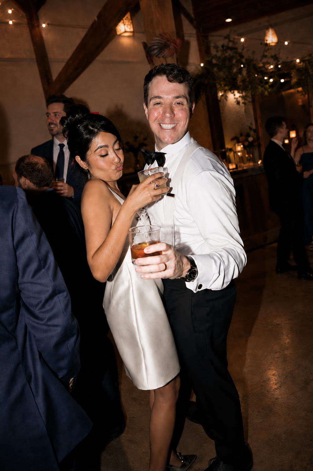 Bride and groom laughing together at their wedding reception