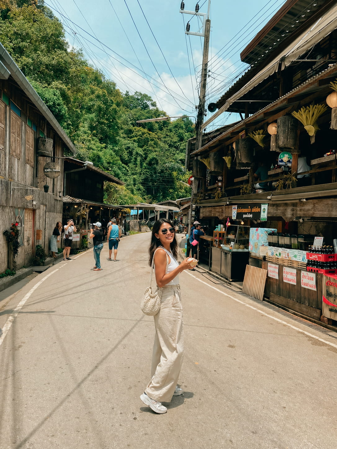 Woman walking through an old wooden street market in Chiang Mai